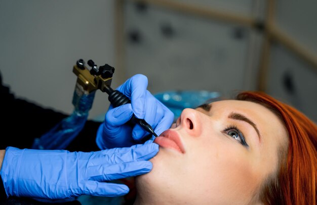 Cosmetologist making permanent makeup on woman's face cropped photo Beauty concept Closeup