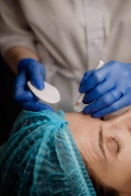 Cosmetologist preparing patient for botox procedure