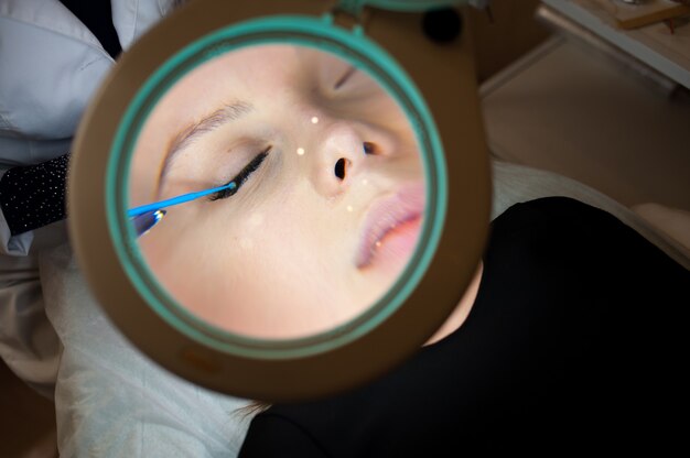 Cosmetology. Beautiful girl in a magnifying glass.