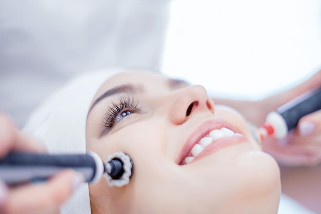 Cosmetology Closeup of microcurrent and ultrasound procedure for face Rejuvenation and lifting