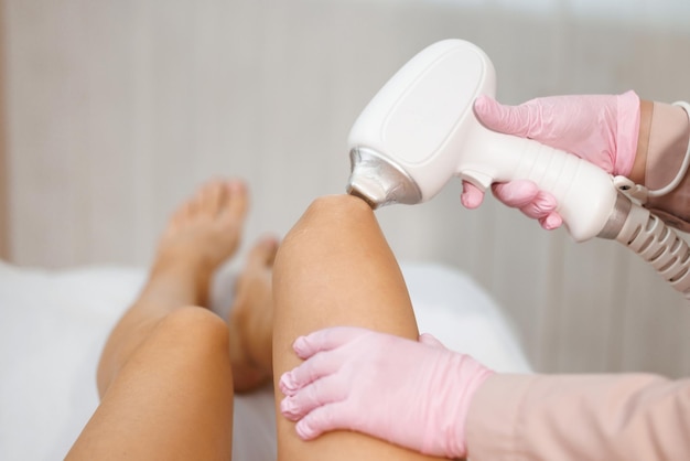Cosmetology hair removal procedure from therapist in a cosmetic spa beauty clinic laser epilation