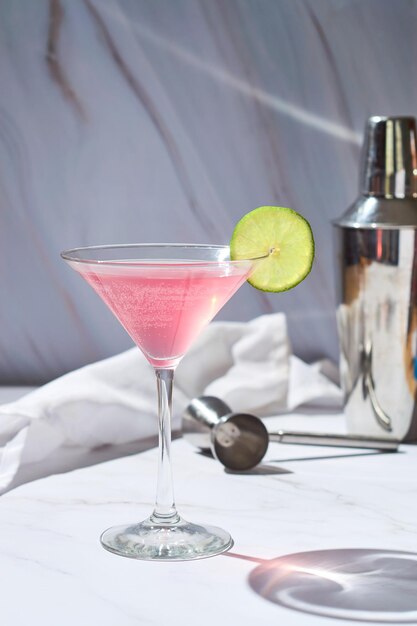 Cosmopolitan cocktail drink served with lime