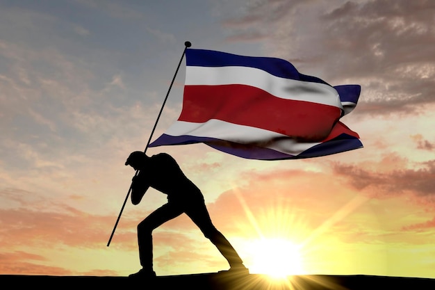 Costa Rica-vlag wordt in de grond geduwd door een mannelijk silhouet 3D-rendering