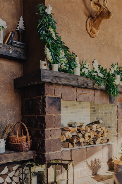 Cosy autumn interior decoration. Christmas fireplace with firewood.