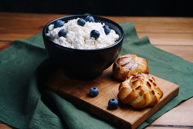 Cottage cheese in bowl served with blueberries