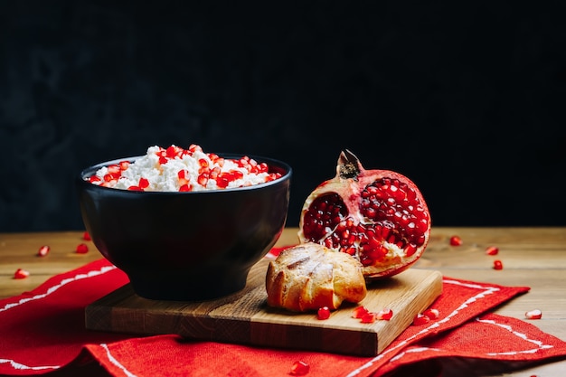 Cottage cheese in bowl served with pomegranate