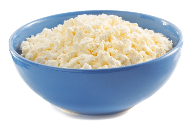 Cottage cheese in bowl on white surface