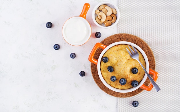 Cottage cheese casserole on baking dish on light background Healthy breakfast Top view