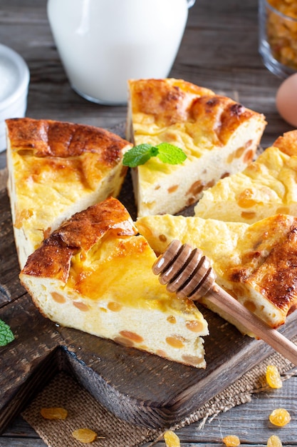 Cottage cheese casserole with raisins on wooden background