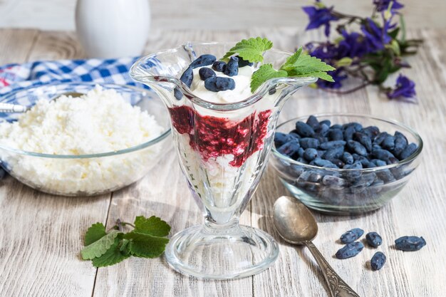 cottage cheese dessert and berry on wooden table 