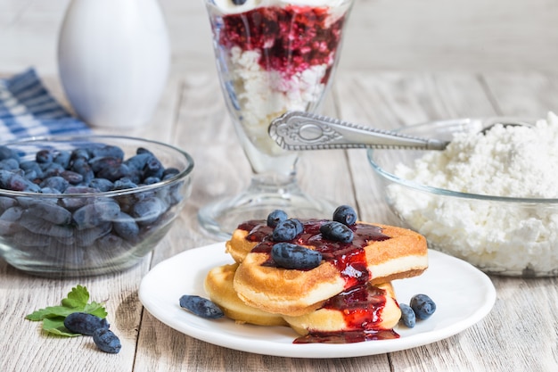 cottage cheese dessert and berry on wooden table 