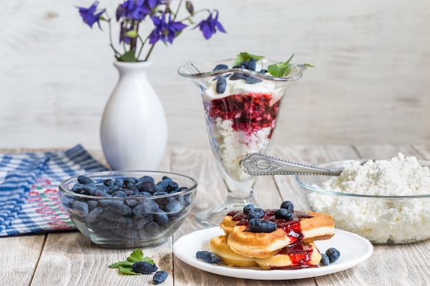 cottage cheese dessert and berry on wooden table 