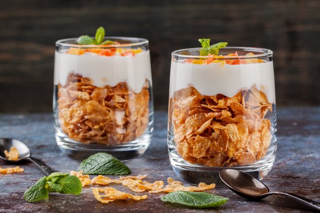 Cottage cheese dessert with cornflakes in glasses