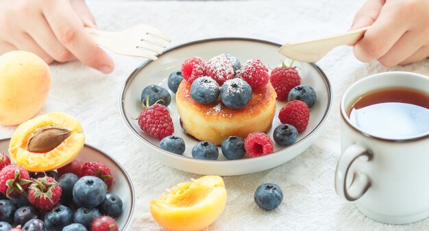 Cottage cheese pancakes with fresh berries and powdered sugar