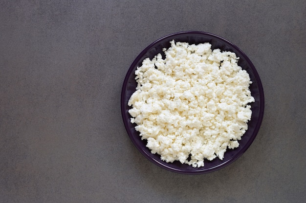 Cottage cheese plate top view on dark table