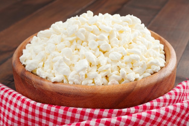 Cottage cheese in rustic wooden plate