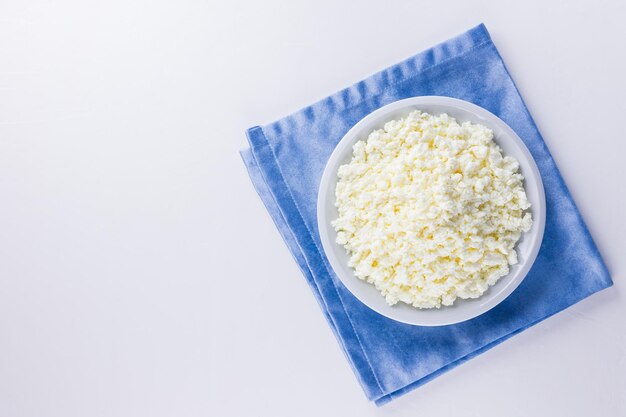 Cottage cheese on white plate Fresh cottage cheese on white background Top view Copy space