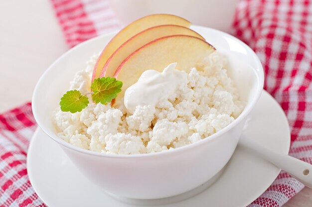 Cottage cheese with apples and sour cream for breakfast close up