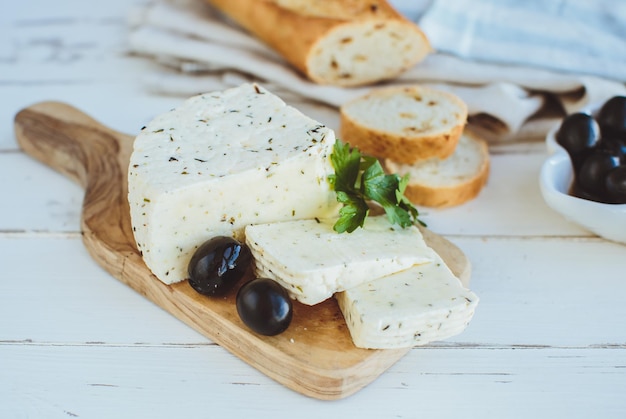 Cottage cheese with baguette and olives