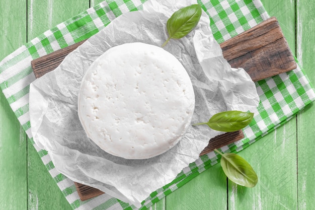 Cottage cheese with basil on a cutting board