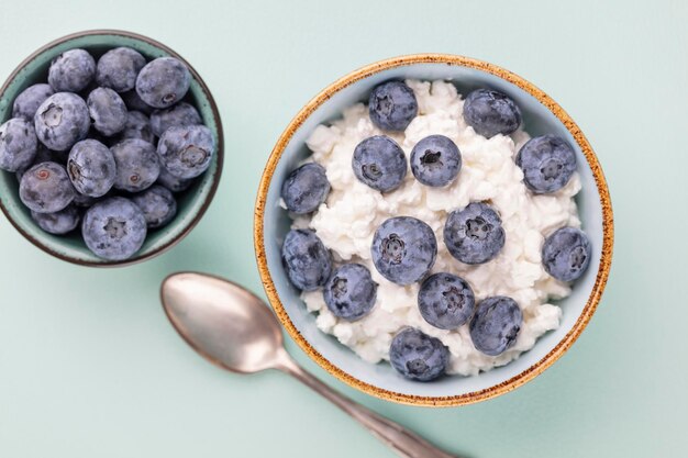 Cottage cheese with blueberry, fresh berries, keto healthy breakfast concept, top view.