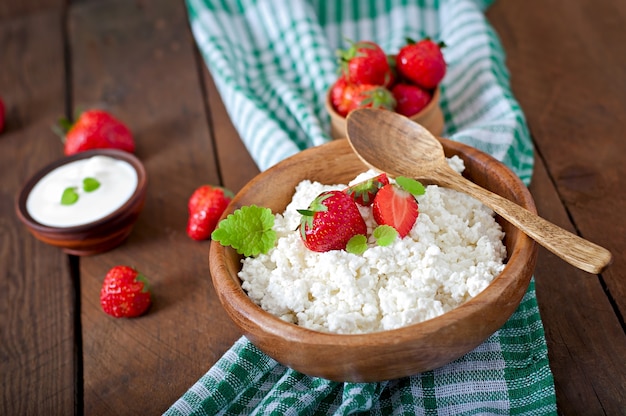 Cottage cheese with strawberries in a wooden bowl