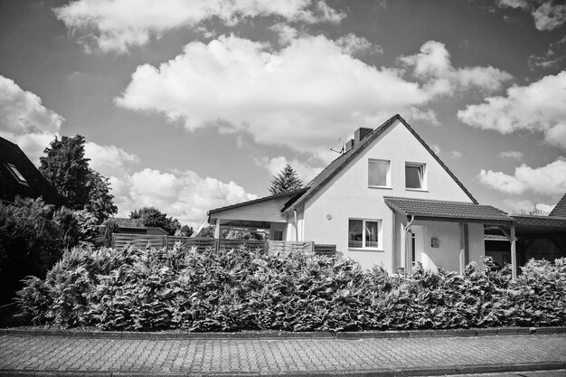 Cottage house on sunny summer day on cloudy blue sky on countryside landscape Real estate concept