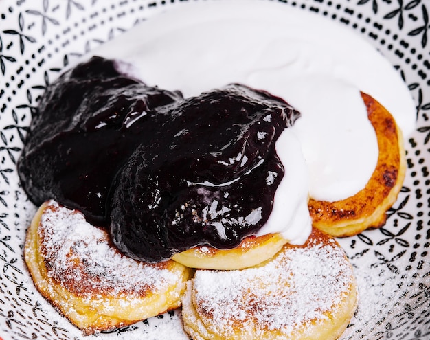 Cottage pancakes with berry jam and sour cream