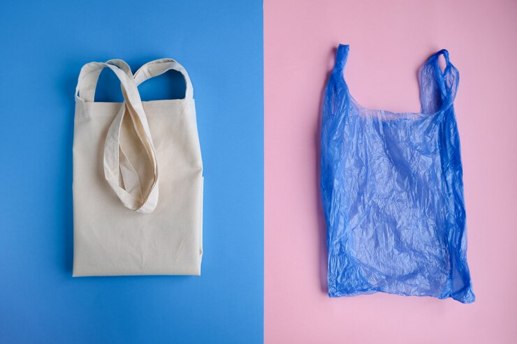 Cotton bag and plastic bag on pink and blue