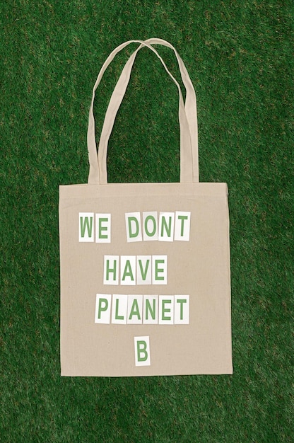 Photo cotton bag with ecological writing on lawn