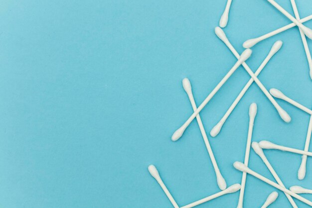 Cotton buds on a blue background Sanitary qtip hygenic accessory Plastic waste