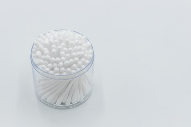 Cotton buds in box on a white background Top view flat lay swabs cotton buds on orange background with copy space