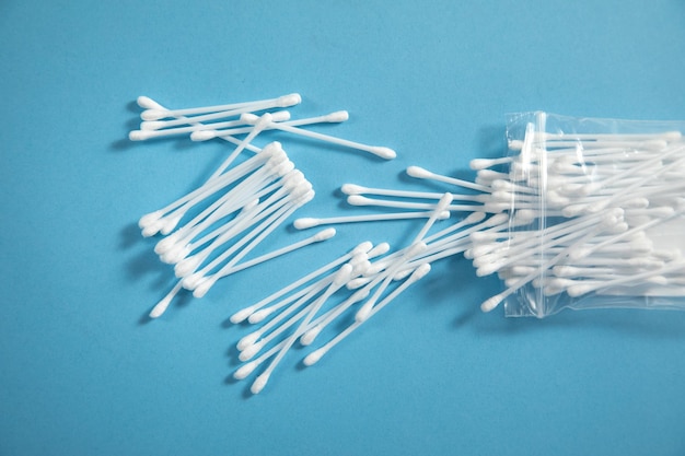 Cotton buds or swabs for ear cleaning on the blue background