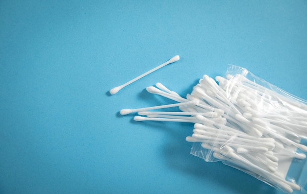 Cotton buds or swabs for ear cleaning on the blue background