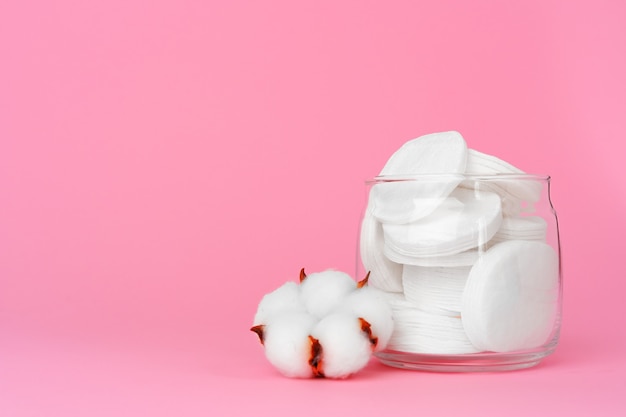 Cotton discs for skincare in a jar on paper surface