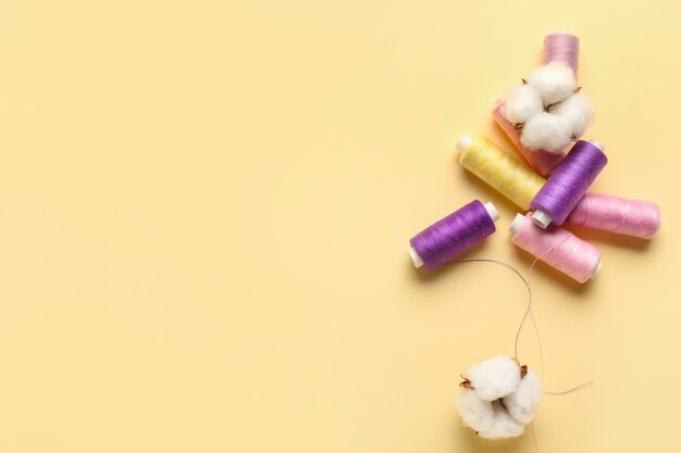 Cotton flowers and threads on beige