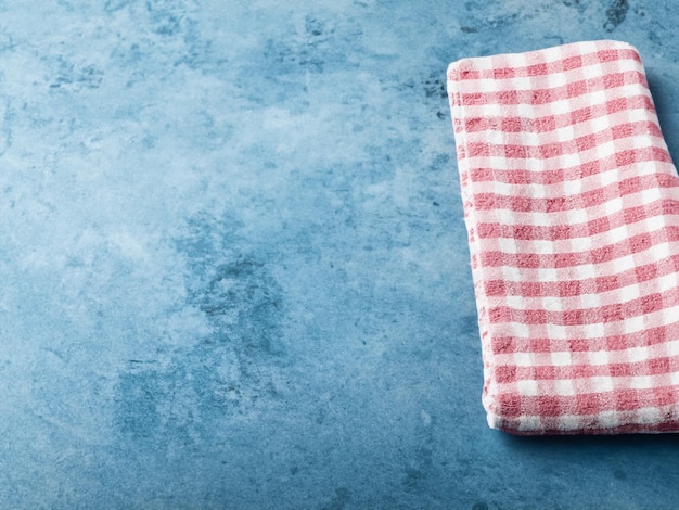 Cotton kitchen napkin or towel over light blue slate stone or concrete table