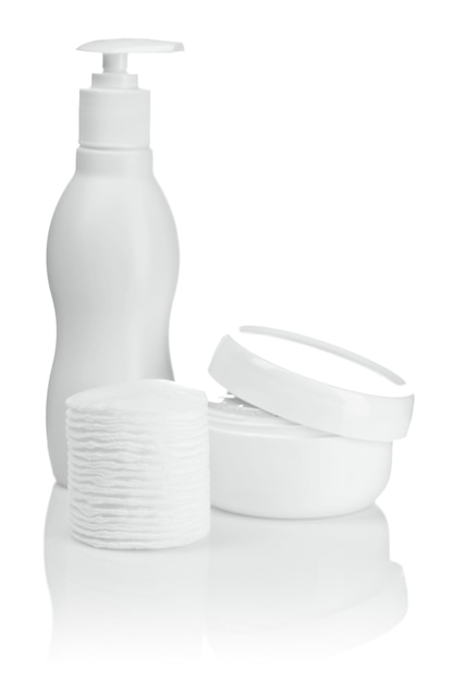 Cotton pads bottle and cream isolated