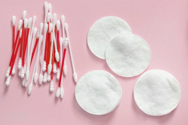 Cotton pads and buds on pink