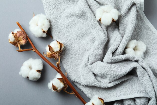 Cotton plant branch and towel on gray