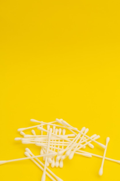 Cotton sticks on a yellow background