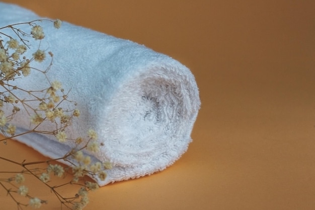 Cotton white towel with branch of gypsophila