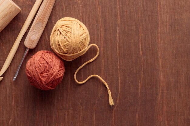 Cotton Yarn Balls for Crocheting Handmade on a Light Colored Wooden background