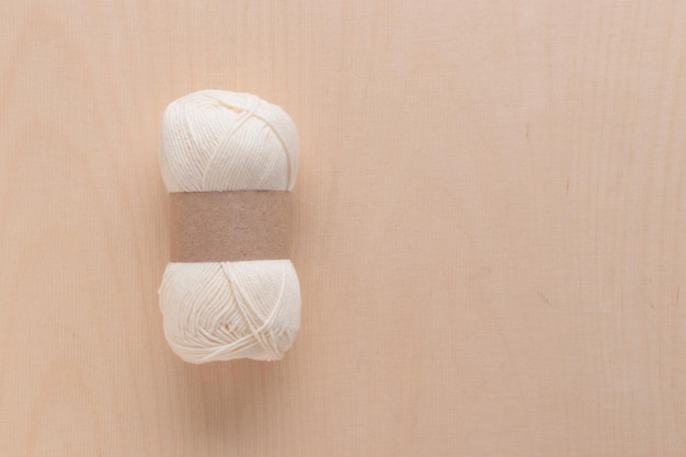 Cotton Yarn Skein for Crocheting Handmade on a Light Colored Wood background
