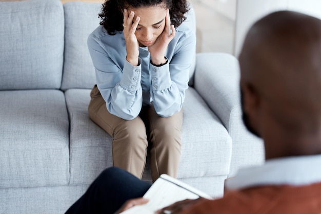 counselling therapy and depression of black woman with mental health problem on psychologist couch patient person talking to therapist man about psychology anxiety and trauma or stress for help