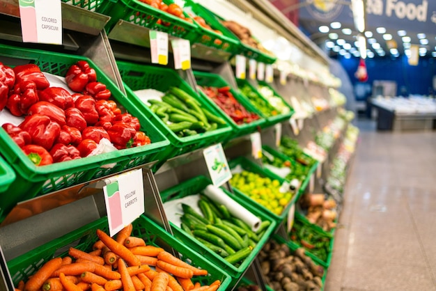 Photo the counter with vegetables in the supermarket