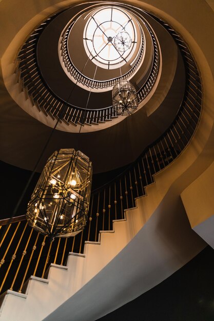 Photo counterpane of a spiral staircase with two large chandeliers