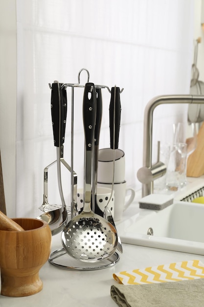 Countertop with sink and cooking utensils in kitchen