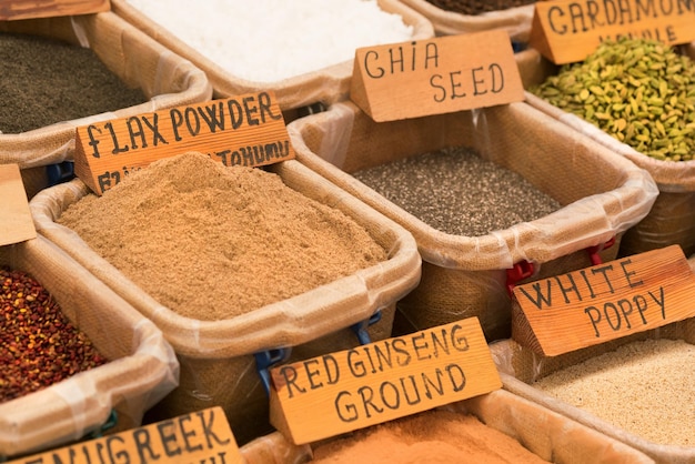 Countertop with a variety of spices tea and flavourings in containers background