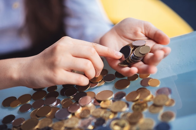 Counting coins. Close up picture of girls hands counting coins